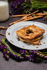 Traditional Latin American sweet bread toast with strawberry and milk, tropical setup

