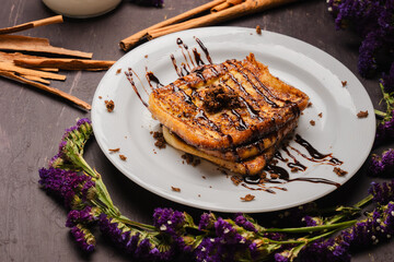 Traditional Latin American sweet bread toast with strawberry and milk, tropical setup

