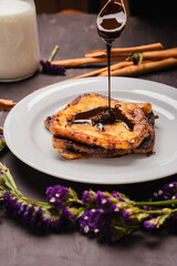 Traditional Latin American sweet bread toast with strawberry and milk, tropical setup

