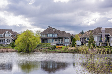 Luxury house with nice spring lake view and green landscape in Vancouver, Canada, North America. Day time on April 2025.