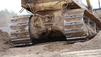 Fototapeta premium A bulldozer digging an excavation at a construction site.