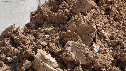 Earth dump of clay-sand soil in construction site excavation. Embankment of clayey soil. Clay.