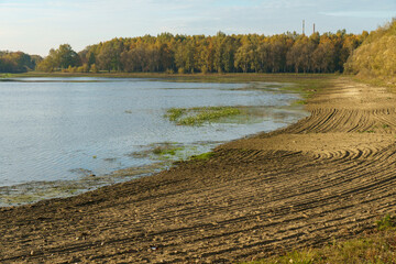 Draining the lake before cleaning. Environmental disaster, pollution of the reservoir and fresh water by waste products.