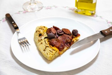 Delicious pizza slice with sausage and olives. Traditional Brazilian calabresa pizza 