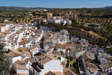 Panoramic view of the beautiful white village of Setenil de las Bodegas since lookout in Cadiz, Spain, with the church and castle in a sunny day.