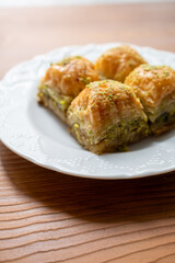 Traditional Turkish homemade baklava on white plate in close-up