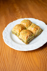 Traditional Turkish homemade baklava on white plate in close-up