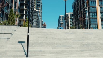 Young man exercising outside. Urban city view of jogger jogging towards camera. Run and doing sport...