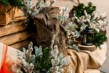 Rustic Christmas Decor Still Life: Wood Logs, Pine Branches, Lanterns, and Burlap with Warm Festive...
