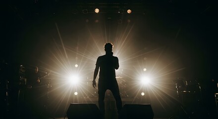 Silhouette of Singer on Stage with Bright Lights and Microphone
