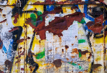 Rusty and colourful door close-up.
