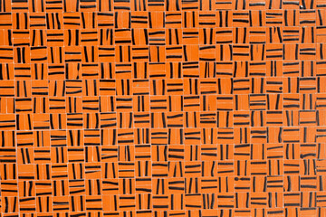 Patterned orange tiles texture background.