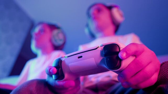 Excited Gamers Kids Brothers Playing Video Game On Console With Gamepad At Home