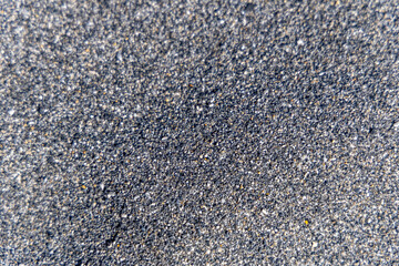 Detailed view of black sand on the coast of Agia Roumeli at the foot of Samaria Gorge showing volcanic granules and rugged island texture