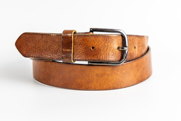 Brown leather belt with vintage finish and silver metal buckle. Classic men's fashion accessory for casual and formal outfits.