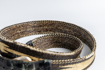 Black leather and woven belt with geometric tribal design and rustic silver buckle. Fashionable and versatile accessory.