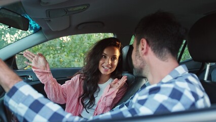 Positive couple talking while sitting in the car. Slow motion