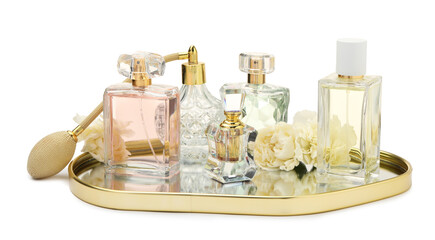 Many different perfume bottles and flowers isolated on white