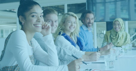 Image of data processing over portrait of diverse male and female colleagues smiling at office