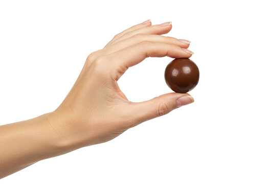 Isolated Close Up Of Hand Holding Chocolate Ball Candy Sweet Treat
