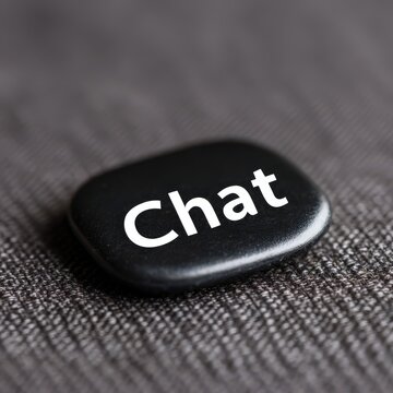 Black button displaying the word chat on textured fabric background representing digital communication innovation and modern conversational interfaces encouraging engagement and connectivity