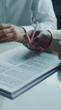 Businesspeople preparing to sign a legal document
