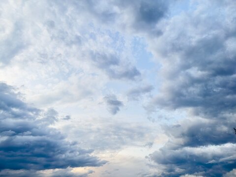 Ominous dark clouds swirling in the sky, weather concept.