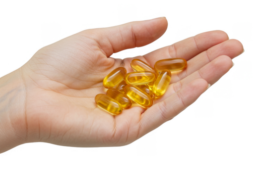 Isolated Image of Hand Holding Transparent Gel Capsules Vitamins Medicine