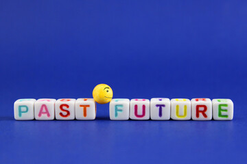 Sphere with a happy face looks toward the future, leaving the past behind, colorful cubes with letters