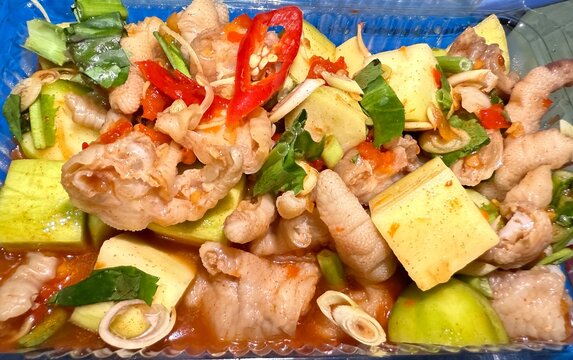 Chan Ga Xa Tac Delicious steamed chicken feet with green mango and sour fruit lemongrass chili herb fish sauce seasoning Vietnamese street food popular Asian cuisine snack healthy food 