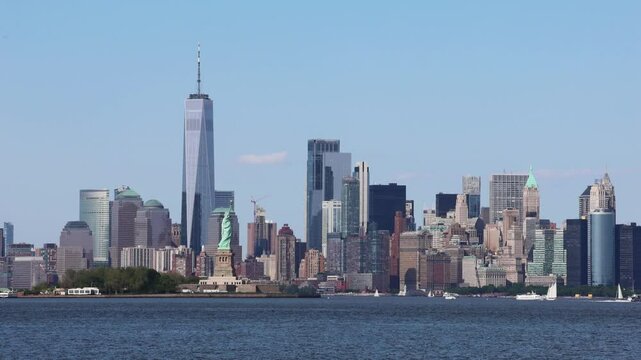 new york city skyline hudson river waterfront view with water moving waves in bayonne jersey harbor downtown manhattan statue financial district clear sky