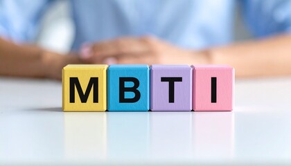 性格診断に使用するMBTIのアルファベット4文字が書かれたカラフルな木製のキューブブロック。aiで生成	