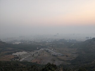 Layered mountain ridges with scattered residential buildings