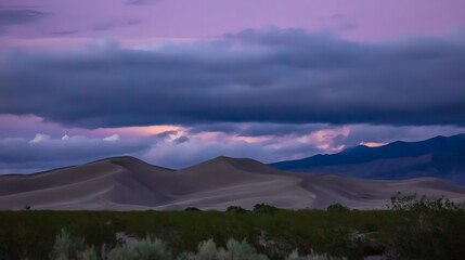 Dunes under colorful sky at dusk