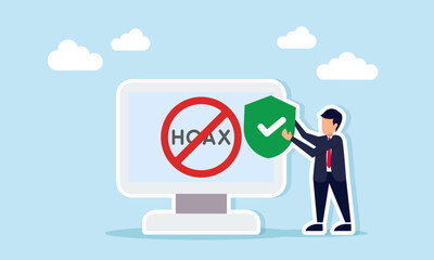 Businessman holding a shield beside a monitor displaying hoax text with a forbidden sign illustration of rejecting false or harmful information