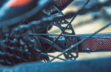 bike mechanics, highlighting disc brakes and spokes. bike’s disc brake system with water drops,...