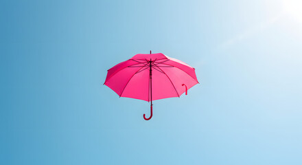 A cheerful pink umbrella suspended or floating against a clear, light blue sky. Represents protection, optimism, lightheartedness, and whimsical freedom.
