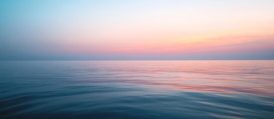 Fototapeta premium Serene sunrise over a tranquil ocean.