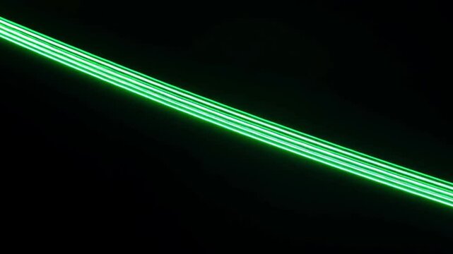 Two glowing parallel green lines diagonally cross the frame against a black background