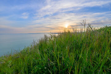 Grassy Cliff Edge Overlooking Calm Black Sea at Twilight