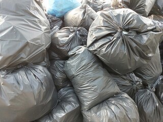 Black Garbage Bags Piled Up in Urban Area