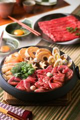 【すき焼き】醤油・砂糖などを混ぜた割り下で煮て溶き卵をからめていただく関東風のすきやき。お豆腐の代わりに車麩を使い鞠麩で華やかに仕上げました。