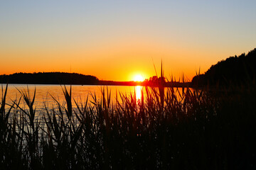 Sunset over the lake, boat on the water