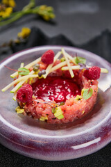 Tuna and avocado tartare with raspberry sauce, bright lighting, minimalist plating, vibrant gourmet presentation