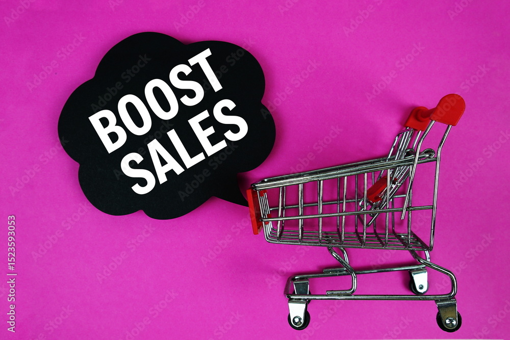 Poster boost sales text with speech bubble and trolley shopping cart on pink background