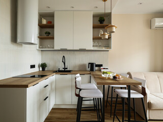 The modern kitchen features a stylish design with bar seating, perfect for cooking and socializing