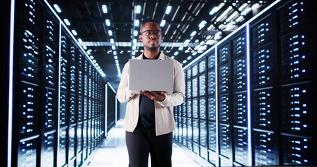 Smiling IT Specialist Configuring Servers In Data Center