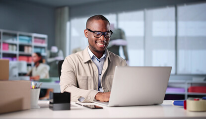 African Fashion Designer Using Laptop