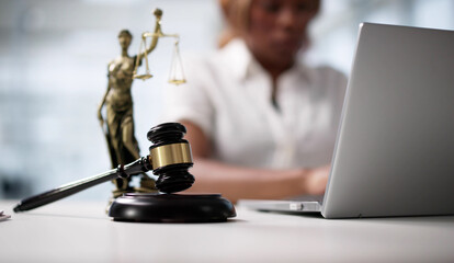 Technology In Law: A Woman Typing On A Laptop In Court