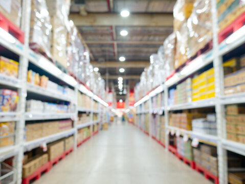 Blurred view of modern supermarket store background. aisle shelves in hypermarket superstore defocused bokeh light background.
